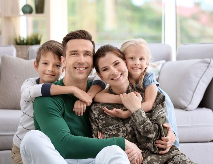 Woman in military uniform with her family at home