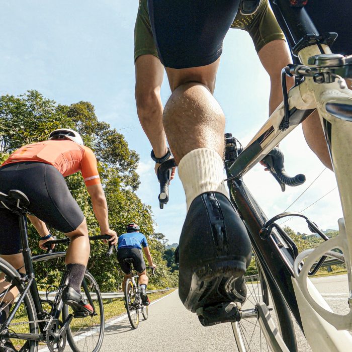 point of view male cyclist competing in sports race cycling event at rural scene