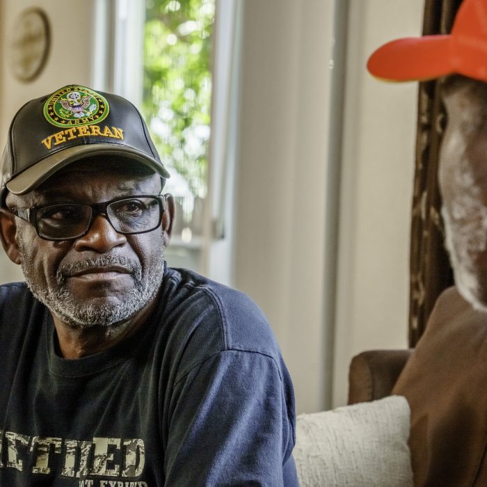 Military Veterans in Their Seventies Having a Casual Conversation in a Residential Living Room