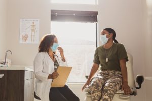 Female army soldier consults doctor
